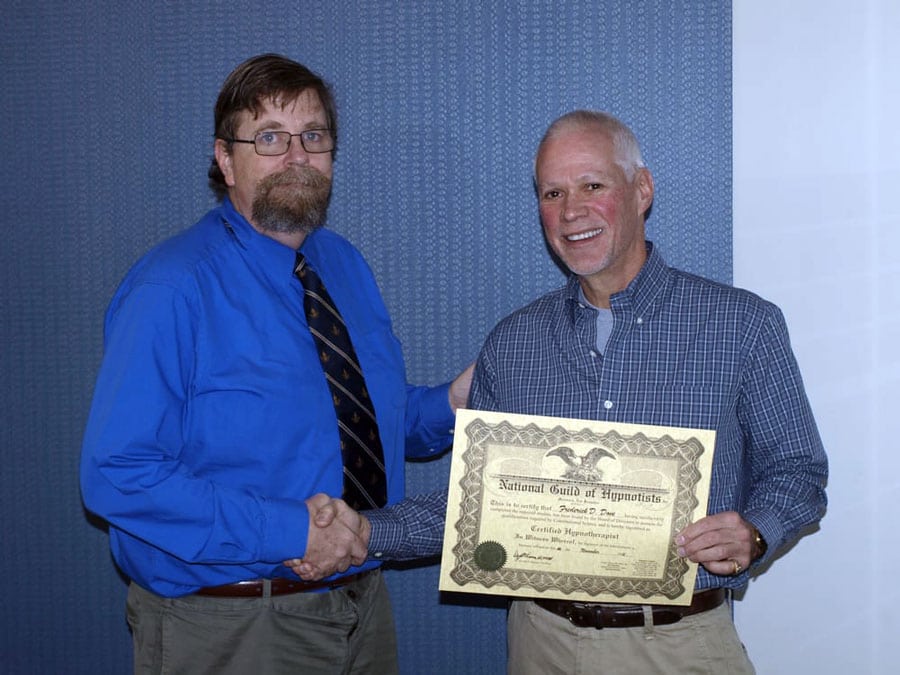 tim horn shaking hand with student